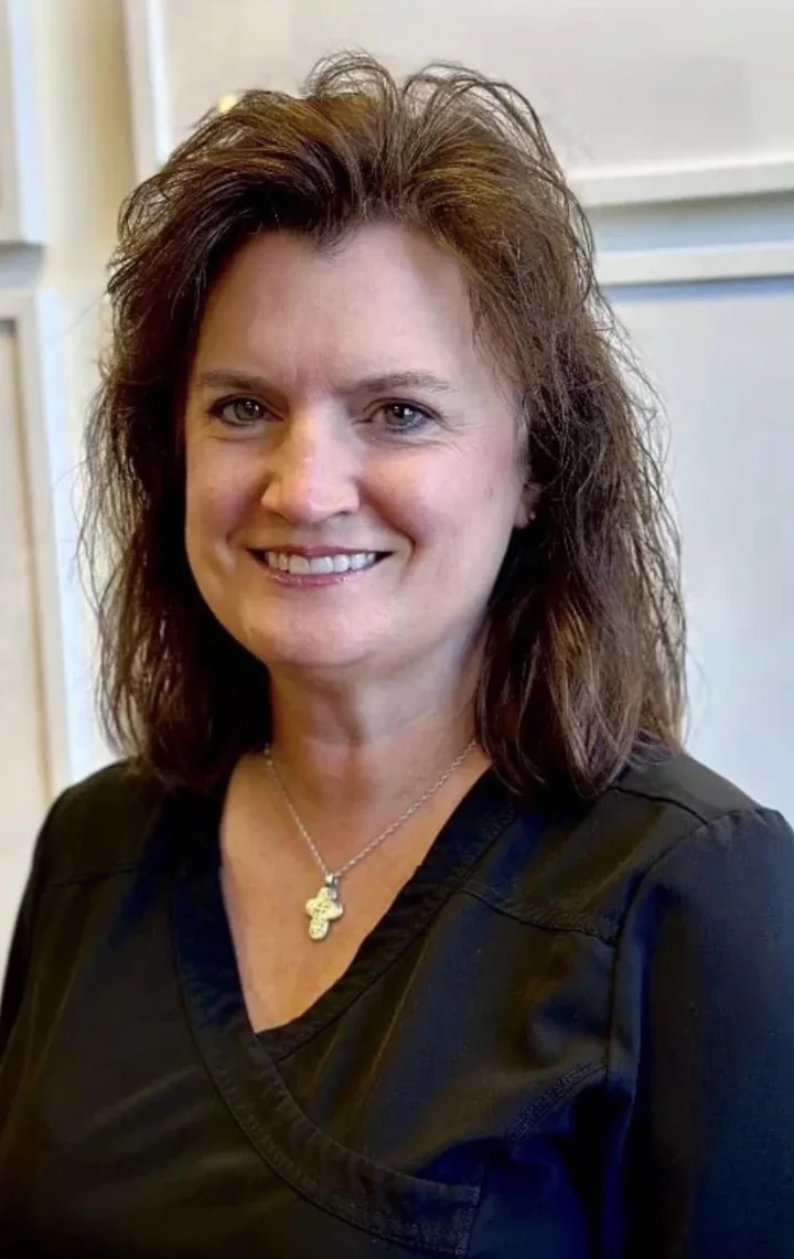 Jennifer, dental hygienist at Apex Dental, wearing black scrubs